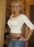 Busty blonde woman in glasses and white top and jeans.JPG