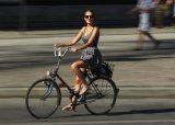 117638917-young-woman-rides-a-bicycle-on-a-hot-day-in-the-city.jpg.CROP.promo-mediumlarge.jpg
