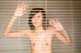 117852616-nude-woman-looking-through-window-blinds-gettyimages.jpg
