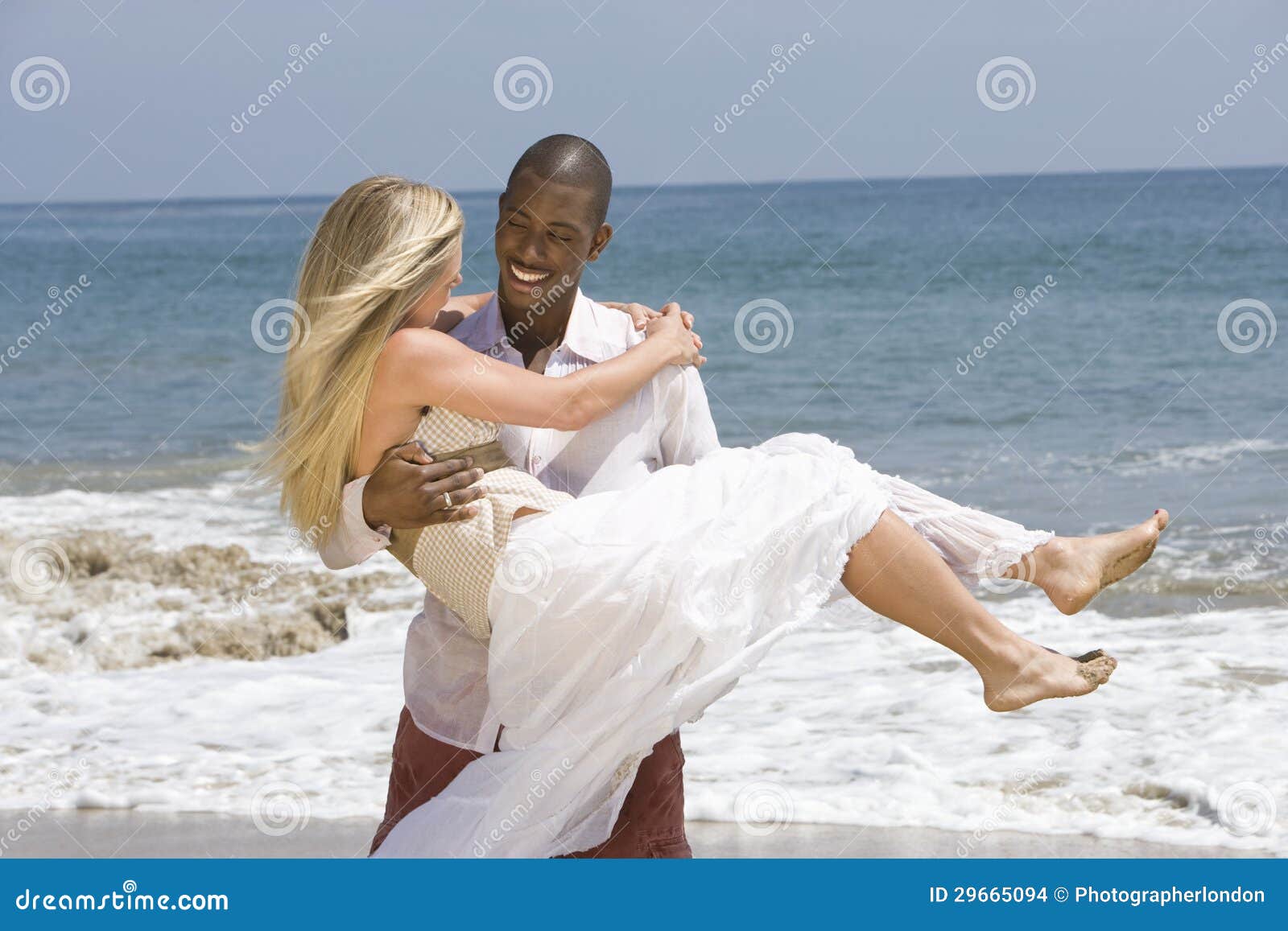 man-carrying-woman-beach-29665094.jpg