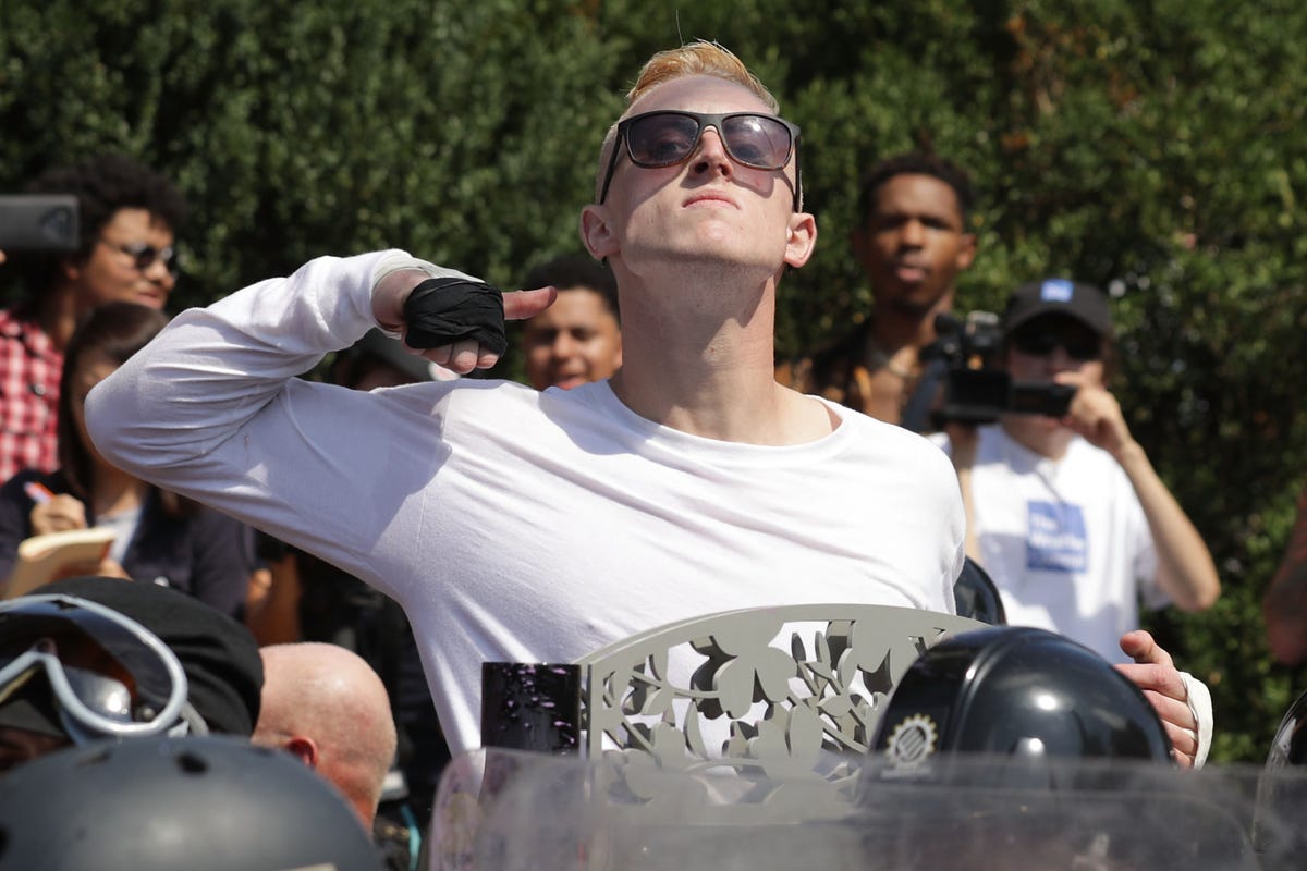 here-one-white-nationalists-makes-a-slashing-motion-towards-the-counter-protesters.jpg