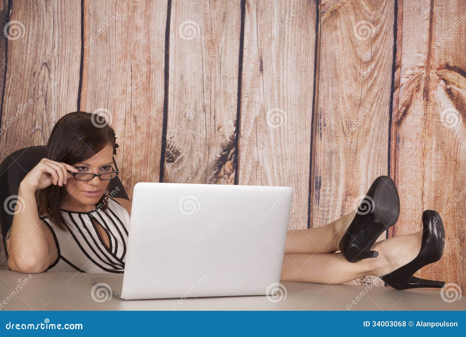 woman-white-dress-computer-wood-sit-legs-up-her-feet-desk-working-her-inside-office-34003068.jpg