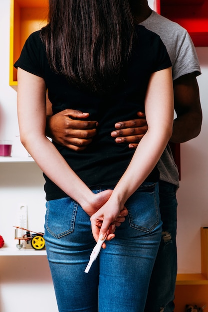 young-unrecognizable-interracial-couple-with-positive-pregnancy-test_201836-2833.jpg